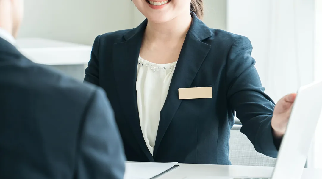 来客に資料を示しながら説明するスタッフ